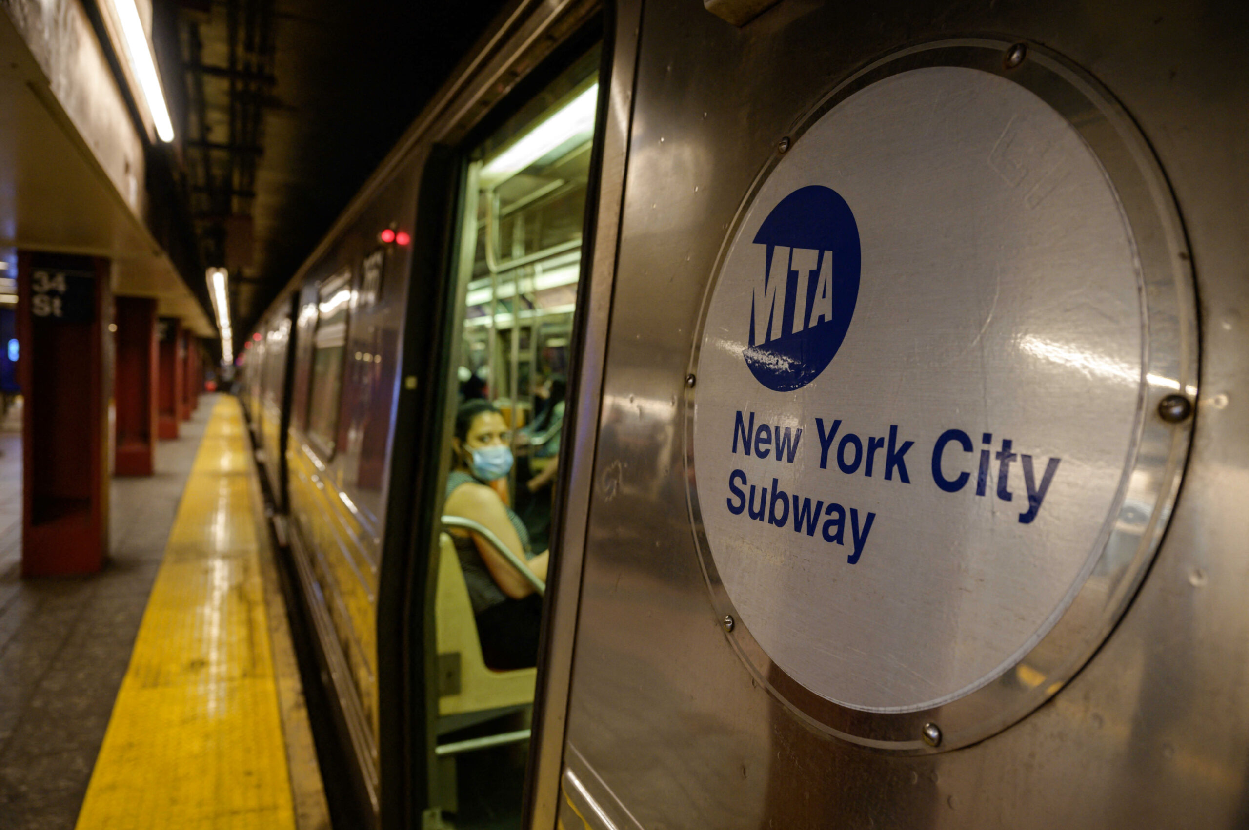 A Metropolitan Transportation Authority (MTA) logo is displayed on the side of a subway train in Manhattan, New York on June 2, 2021. Ed Jones | AFP | Getty Images