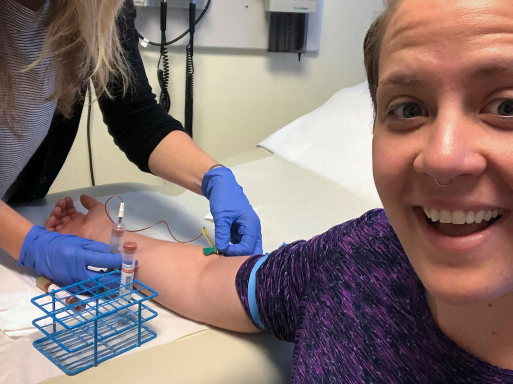 Carolina Reid getting her blood drawn as part of a clinical trial for new experimental malaria vaccine based upon live malaria parasites.